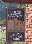 A sign with a picture of a canyonDescription automatically generated