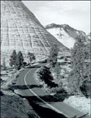A road going through a mountainDescription automatically generated